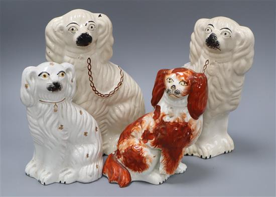 Four Staffordshire pottery figures of spaniels